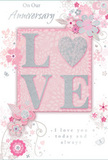In this image, an anniversary card is presented with the quiet grace of a thoughtfully arranged bouquet, the sort you might send to a loved one in Upper Clapton on a meaningful date. The focal point is the word LOVE, spelled in large, raised letters that shimmer with a fine dusting of blush-pink, pearlescent white, and delicate silver glitter. The raised design provides a clear, tactile contrast against the smooth card, encouraging fingers to skim the surface and feel each letter's shape. The background is a gentle, misty pink, subtly deepening around the word so it feels softly illuminated, as if lit by afternoon light filtering in through a window over the rooftops near the River Lea. Around this central element, a graceful arrangement of stylised flowers and curling foliage meanders across the card. Each blossom is drawn with thin, expressive lines and subtle shading in shades of blush, mauve, ivory, and gentle grey. Occasional silver highlights on petals and leaves catch the light like tiny drops of water. The flowers and leaves curve and overlap in a way that recalls the natural drape of stems in a hand-crafted anniversary bouquet, echoing the artistry seen in local Upper Clapton florists. Interspersed among the blooms are fine flourishes, faint butterflies, and delicate swirls, adding an almost whisper-like movement without cluttering the design. Inside, in a soft, flowing script, the text On Our Anniversary and I love you today and always appears, spaced with care so the words feel quiet and sincere. The card's overall atmosphere is one of tender celebration and intimate reflection, a paper keepsake perfectly suited to sit alongside fresh flowers in an Upper Clapton home, marking another year of shared stories and gentle affection.